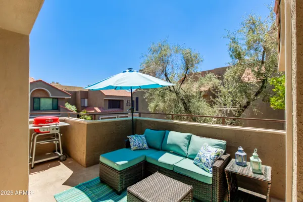 a view of a balcony with furniture and a potted plants
