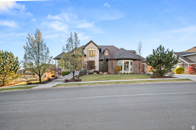 1205 North Elk Rdg Lane, Unit 202 Alpine, UT 84004 - Photo 4 of 88 Stone and brick exterior featuring a multi-gabled roofline, a curved bay window, and extensive landscaping