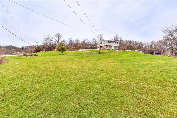 an empty room with windows and ceiling fan