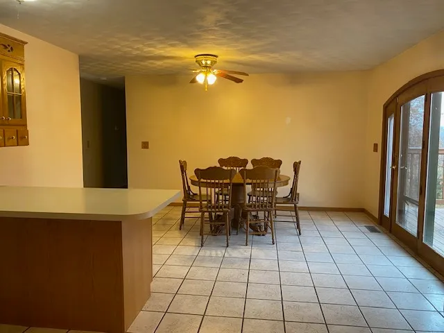 a view of a dining room with furniture and a chandelier