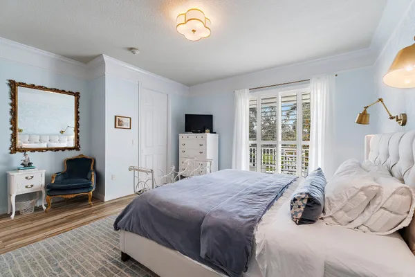 a bedroom with a bed and a large window