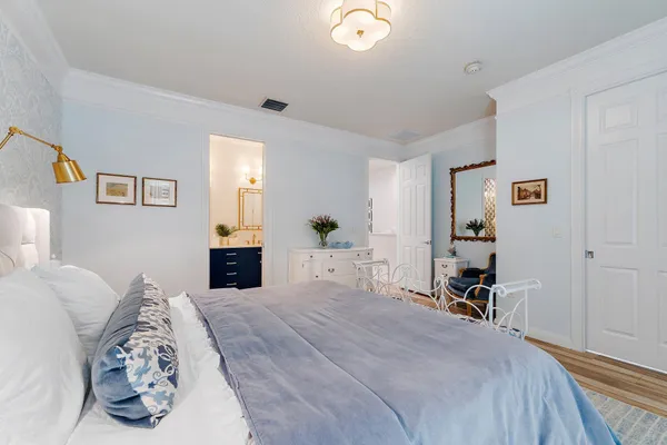 a bedroom with a bed and a chandelier