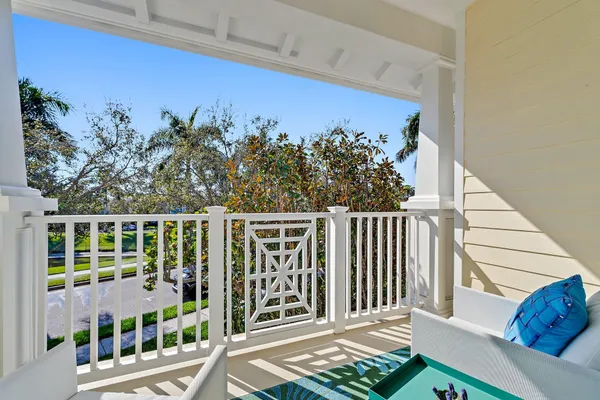 a view of a chairs and table on the balcony