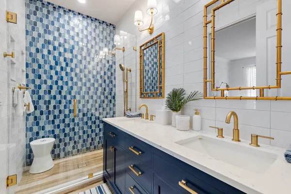 a bathroom with a sink a toilet and a mirror