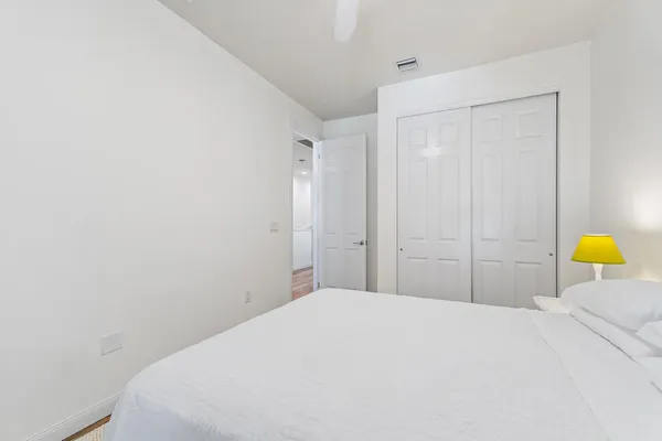 a bedroom with a bed and a lamp