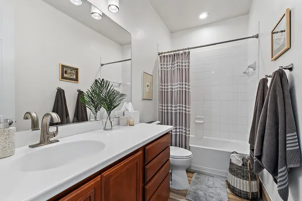 a bathroom with a double vanity sink toilet and shower