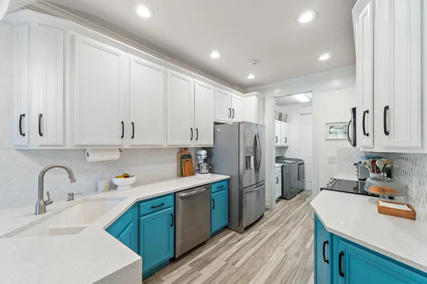 a kitchen with refrigerator and cabinets
