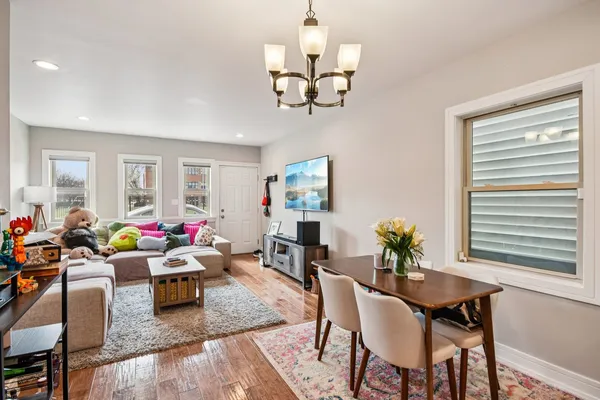 a living room with lots of furniture and a chandelier
