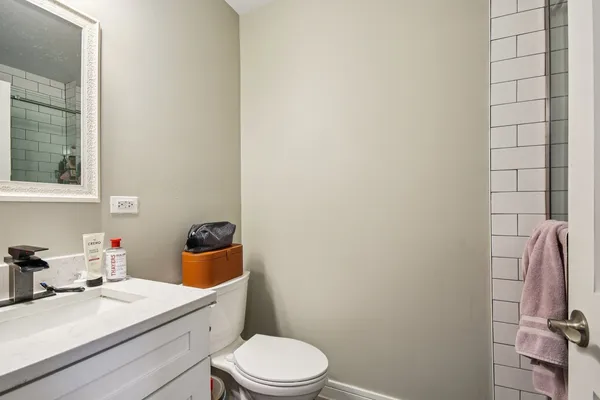 a bathroom with a sink a toilet and vanity