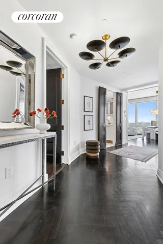 a large white kitchen with stainless steel appliances granite countertop a sink and dishwasher a stove with wooden floor