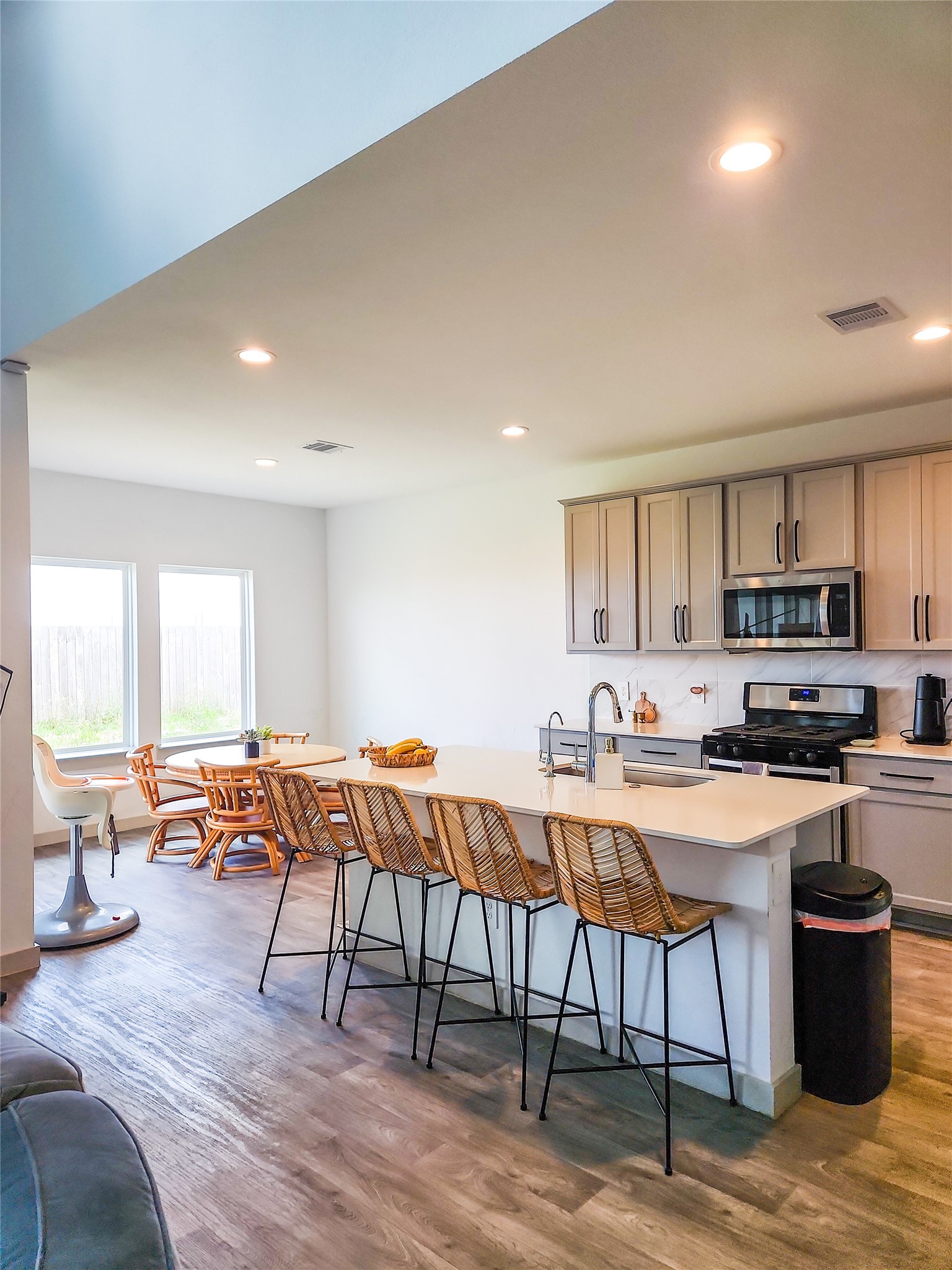 7219 Sunbreeze Lane Rosenberg, TX 77469 - Photo 6 of 18 a kitchen with stainless steel appliances a table and chairs in it