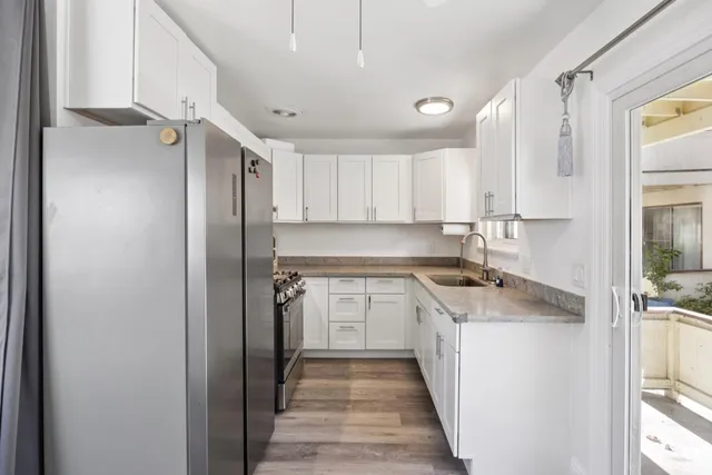 a view of a hallway with wooden floor and stairs