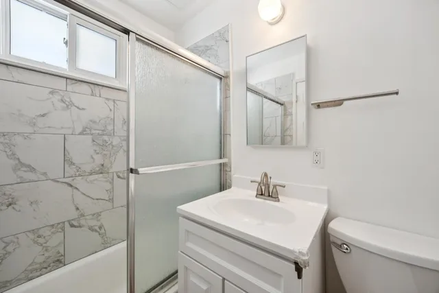 a view of a workspace with furniture and a flat screen tv