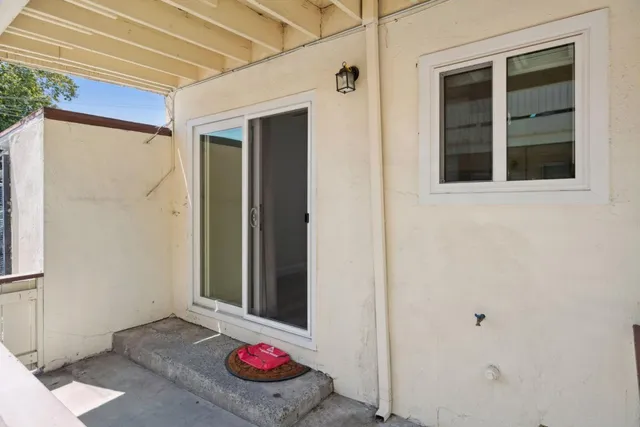 a living room with furniture toys and a large window
