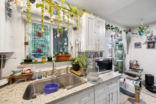 a dining room with furniture a rug and a floor to ceiling window