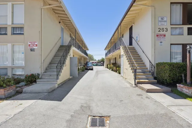 a kitchen with granite countertop a sink stove and cabinets