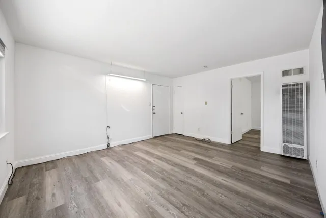 an empty room with wooden floor