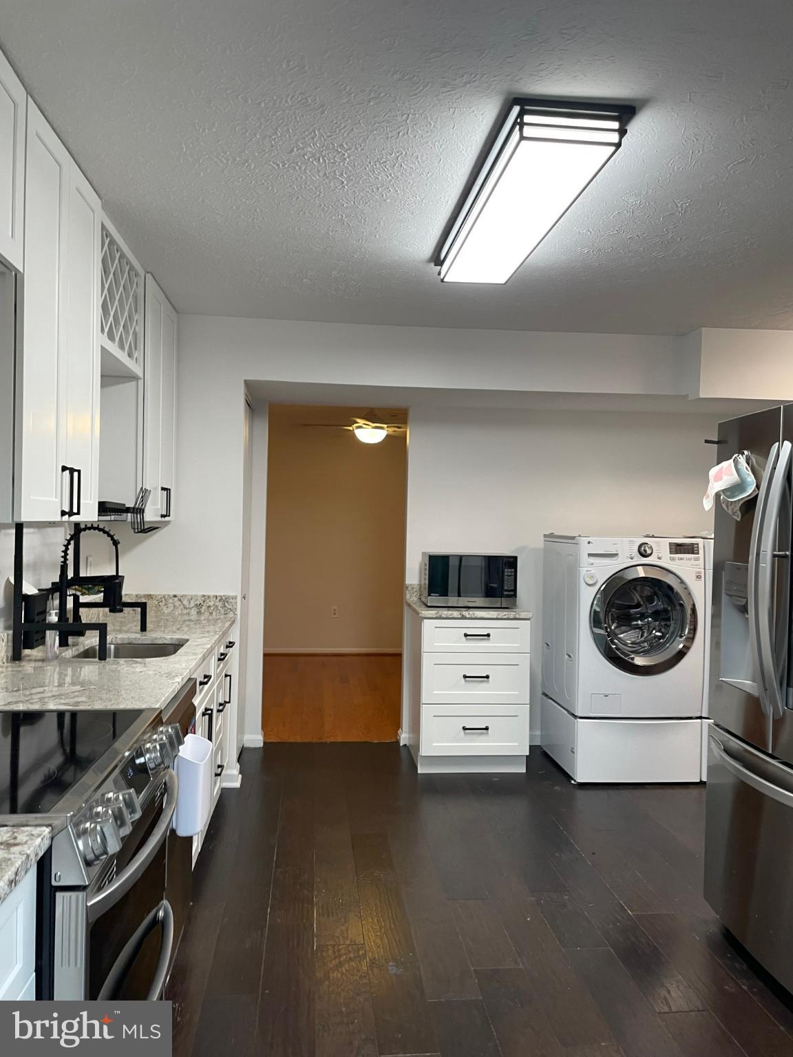 7105 Split Rail Lane Laurel, MD 20707 - Photo 7 of 12 a kitchen with a stove and a refrigerator
