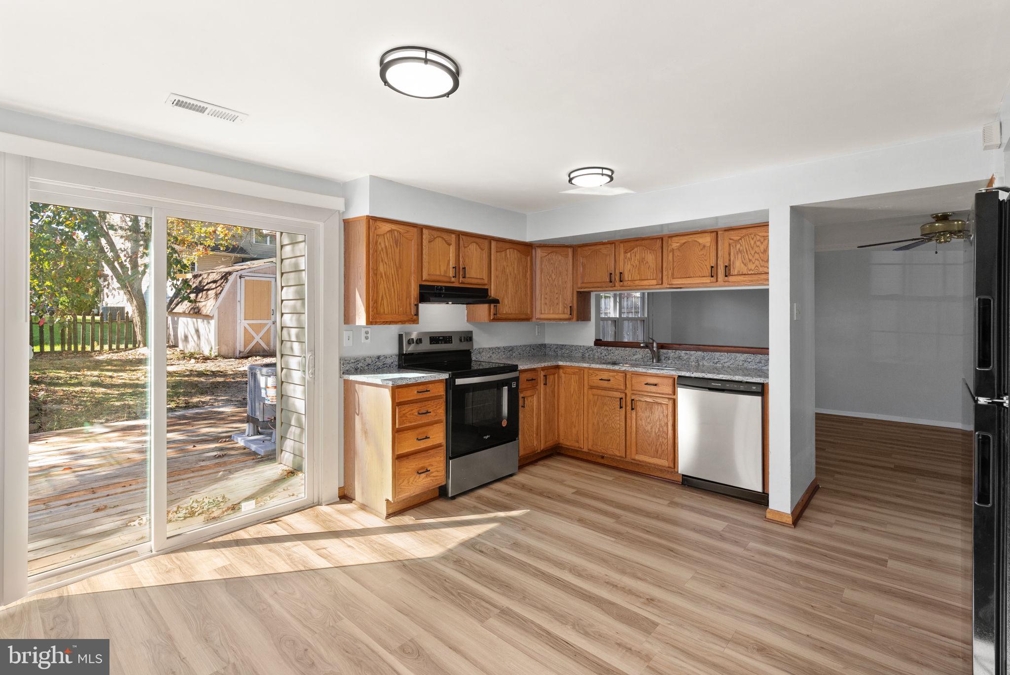 126 Laburnum Road Edgewood, MD 21040 - Photo 12 of 30 a kitchen with granite countertop a refrigerator cabinets and wooden floor