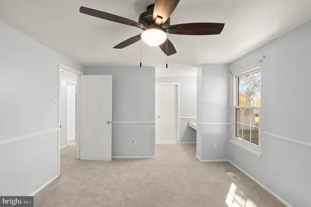 a kitchen with granite countertop a refrigerator cabinets and wooden floor