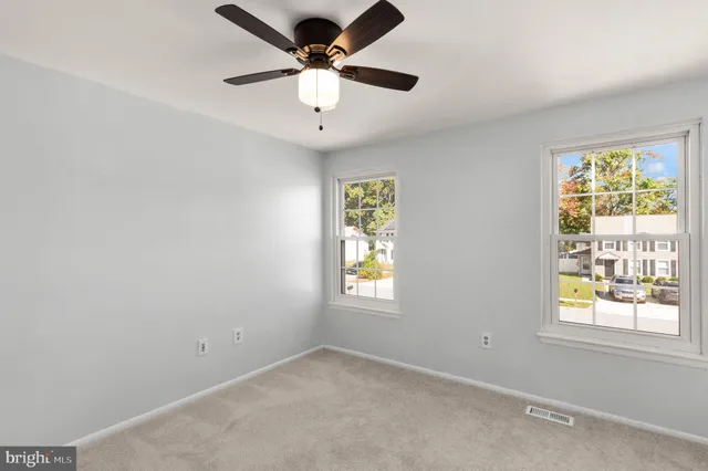 a bathroom with a granite countertop toilet a sink and mirror