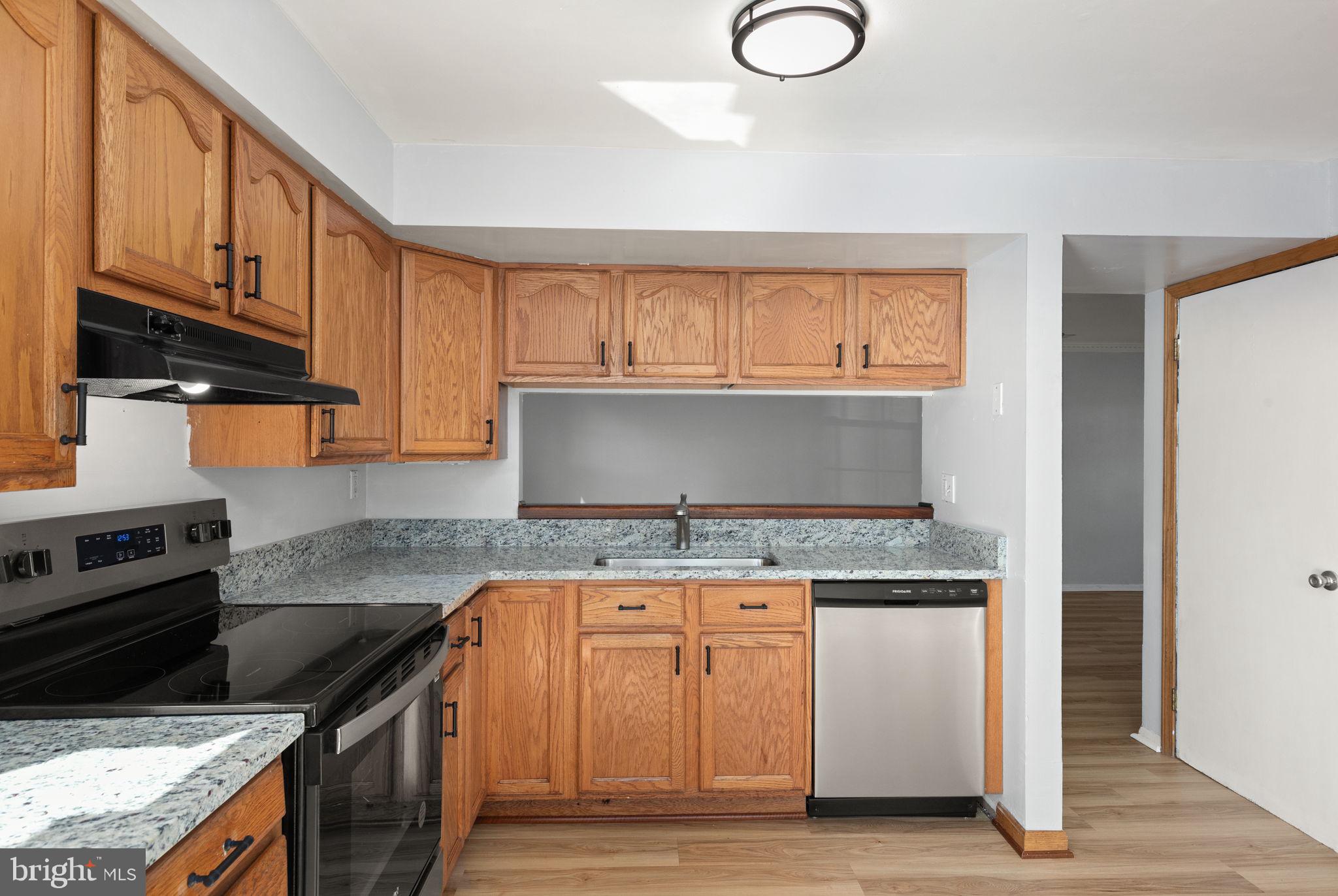 126 Laburnum Road Edgewood, MD 21040 - Photo 8 of 30 a kitchen with granite countertop a stove and cabinets