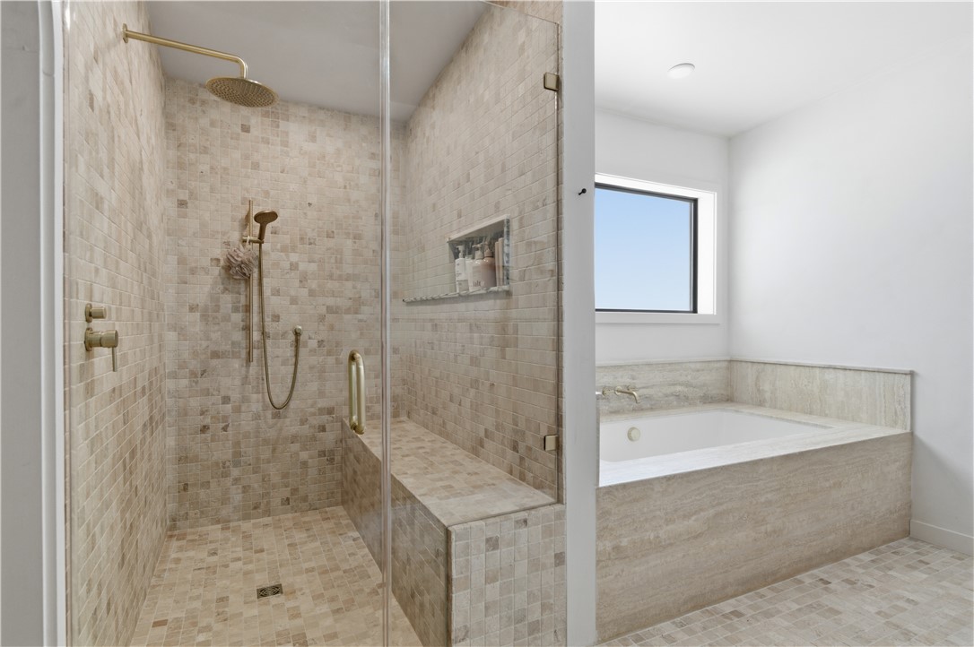 805 Vine Street Bryan, TX 77802 - Photo 25 of 45 Walk in shower with travertine and marble accents