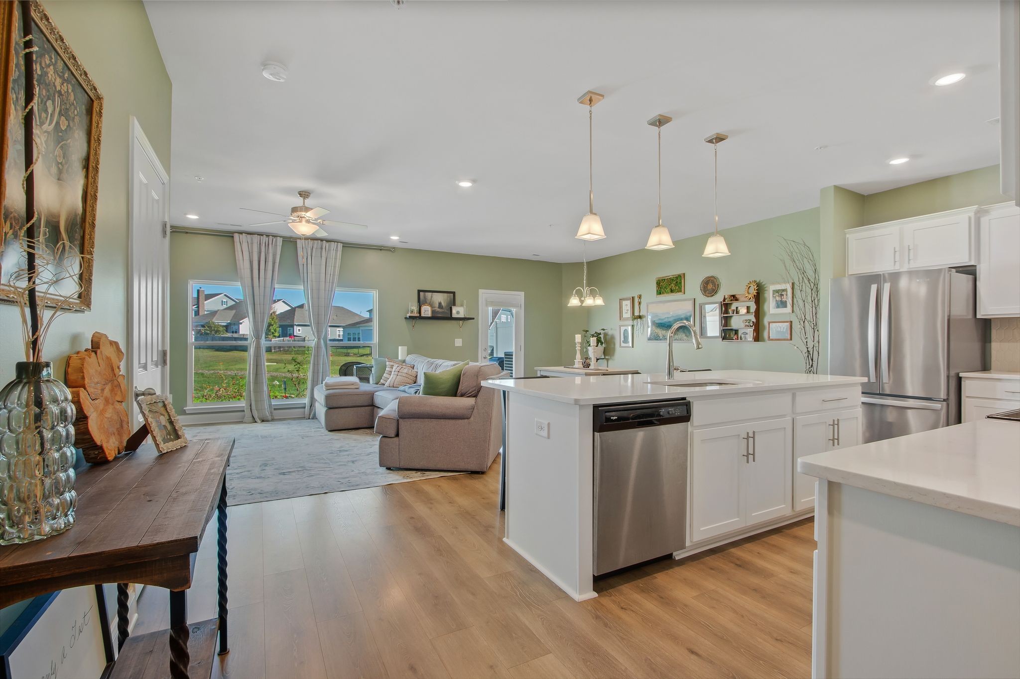 1012 June Wilde Ridge Spring Hill, TN 37174 - Photo 6 of 49 a kitchen with stainless steel appliances kitchen island granite countertop a stove and a wooden floors