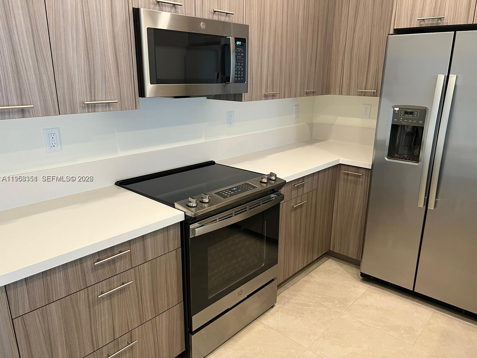 4622 Northwest 83rd Path Doral, FL 33166 - Photo 11 of 13 a kitchen with a stove microwave and refrigerator