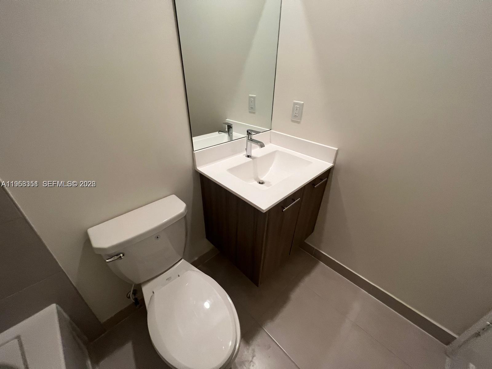 4622 Northwest 83rd Path Doral, FL 33166 - Photo 12 of 13 a bathroom with a sink toilet and mirror