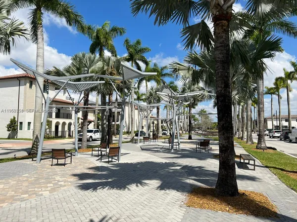 a view of a street with palm trees