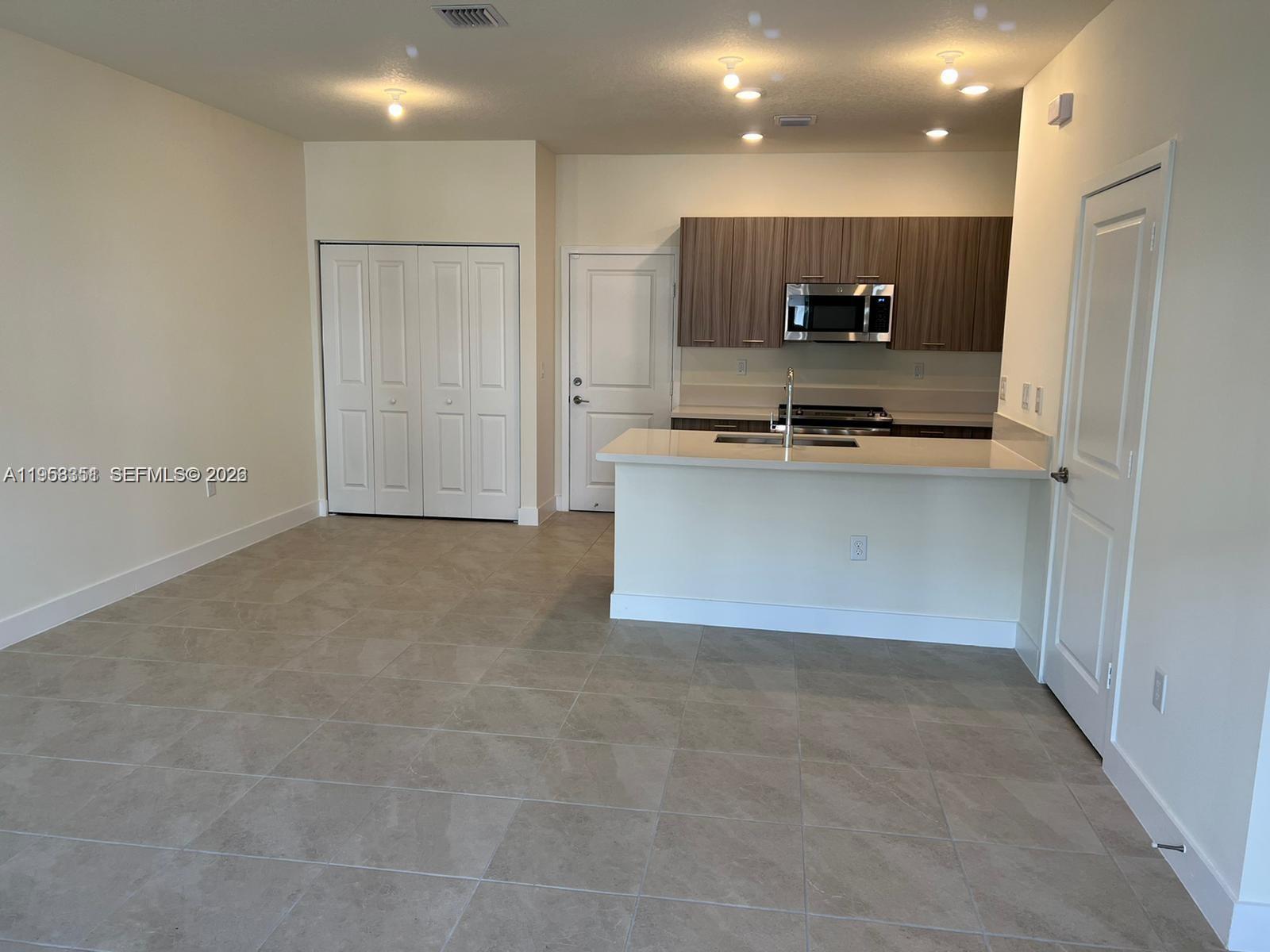 4622 Northwest 83rd Path Doral, FL 33166 - Photo 5 of 13 a view of kitchen with stainless steel appliances a refrigerator and a sink