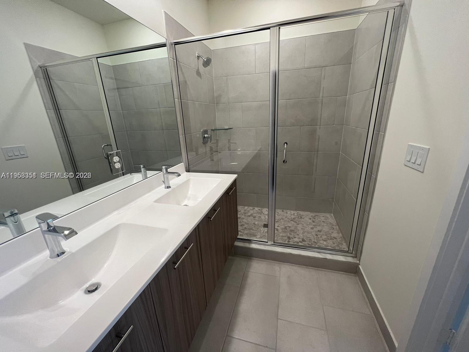 4622 Northwest 83rd Path Doral, FL 33166 - Photo 8 of 13 a bathroom with a sink a toilet and shower