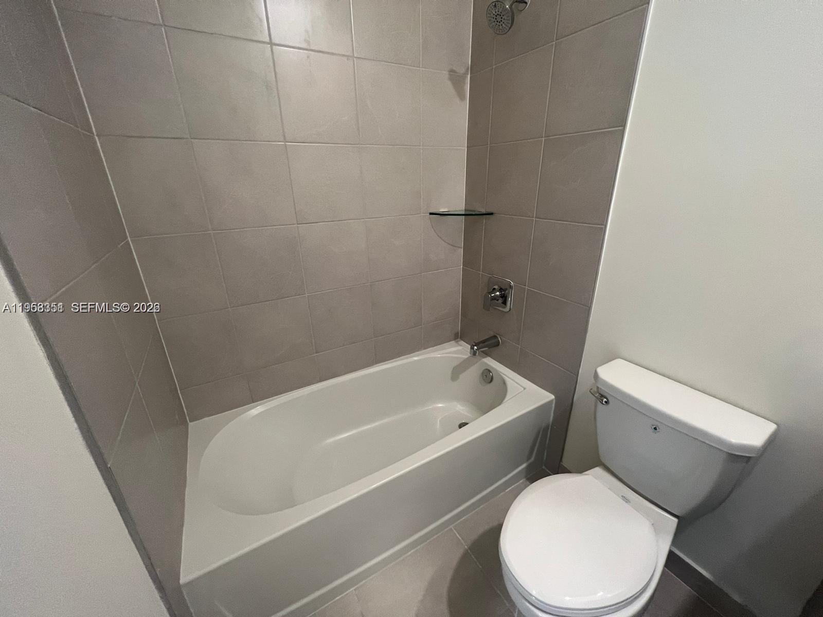 4622 Northwest 83rd Path Doral, FL 33166 - Photo 9 of 13 a white toilet sitting next to a bathtub