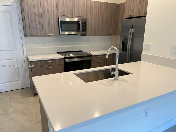 a kitchen with a stove microwave and refrigerator