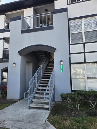 a view of front door of house with stairs