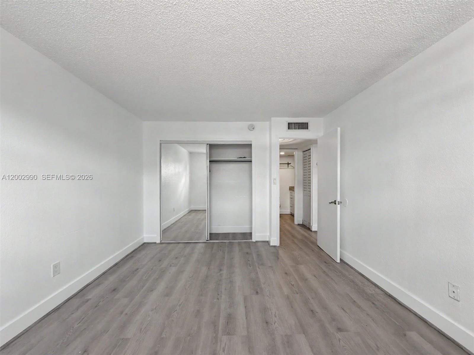 606 West 81st Street, Unit 120 Hialeah, FL 33014 - Photo 3 of 14 a view of an empty room with wooden floor