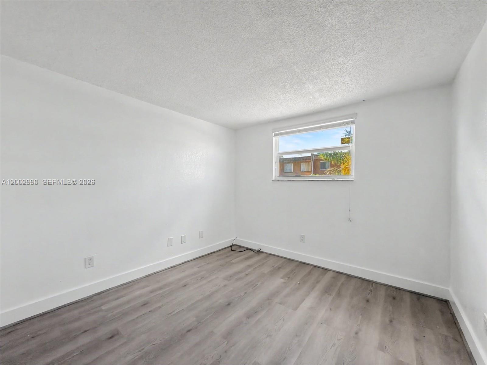 606 West 81st Street, Unit 120 Hialeah, FL 33014 - Photo 5 of 14 an empty room with a workbench
