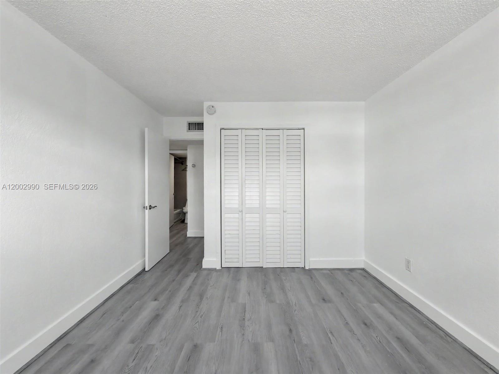 606 West 81st Street, Unit 120 Hialeah, FL 33014 - Photo 7 of 14 wooden floor in an empty room