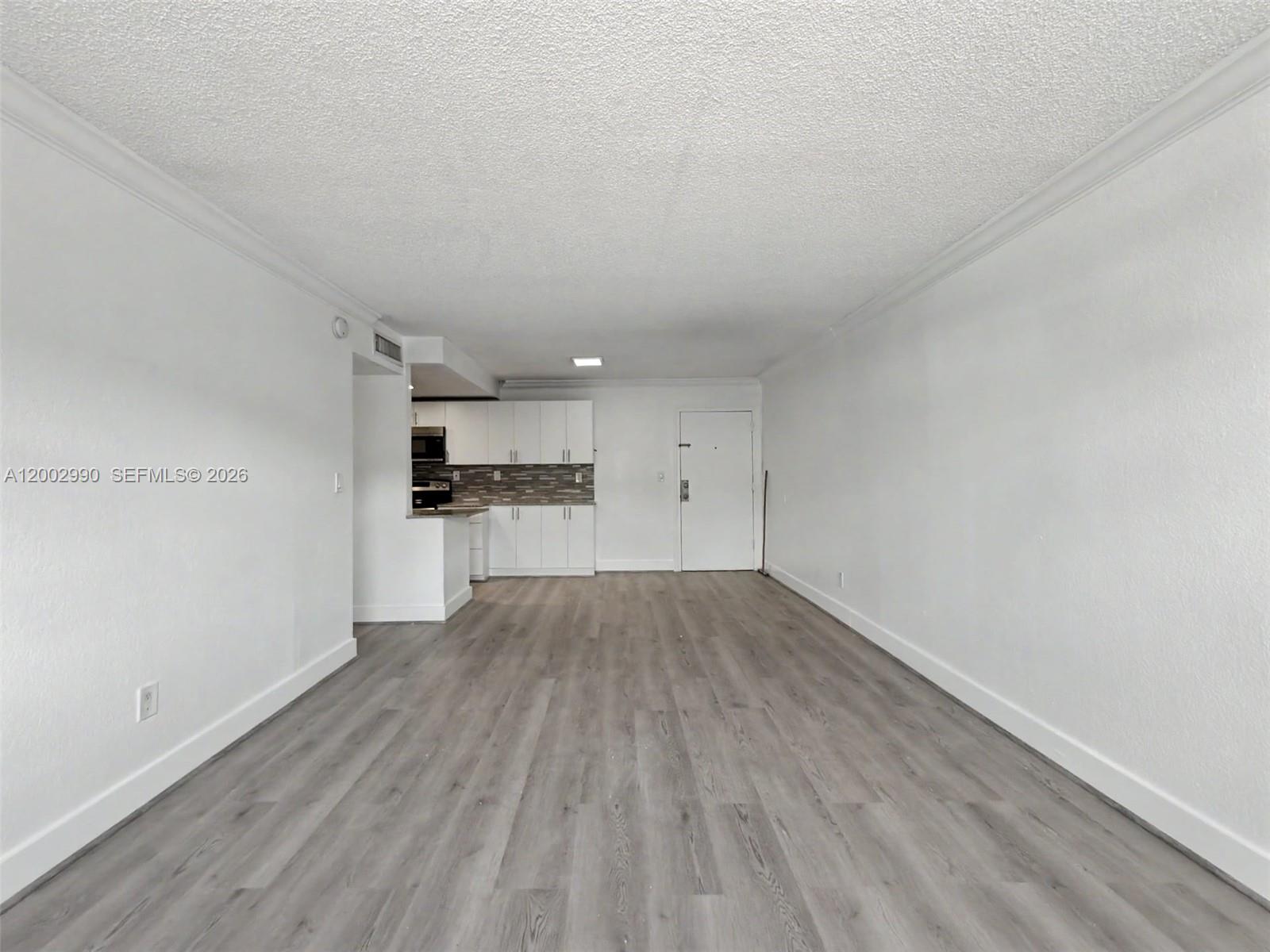 606 West 81st Street, Unit 120 Hialeah, FL 33014 - Photo 8 of 14 a view of a kitchen with wooden floor and cabinets