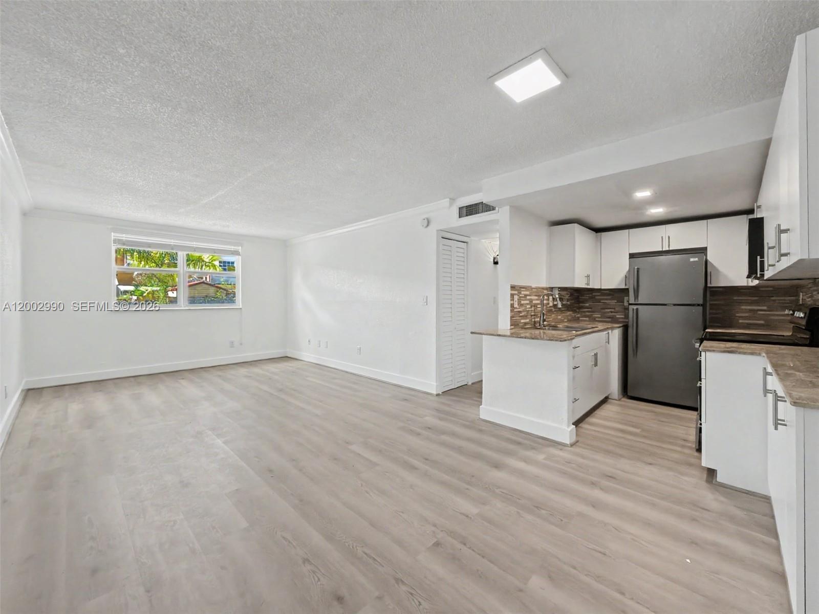 606 West 81st Street, Unit 120 Hialeah, FL 33014 - Photo 9 of 14 a view of kitchen appliances wooden floor and window