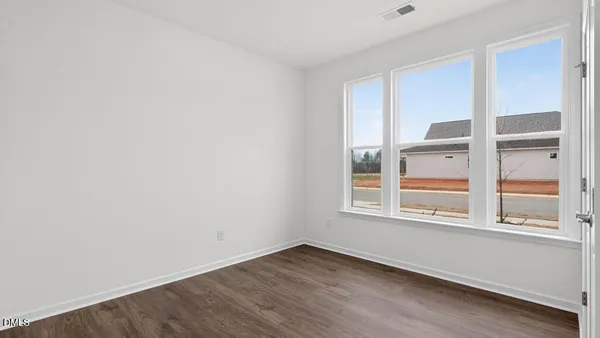 a kitchen with kitchen island granite countertop a sink stove and refrigerator
