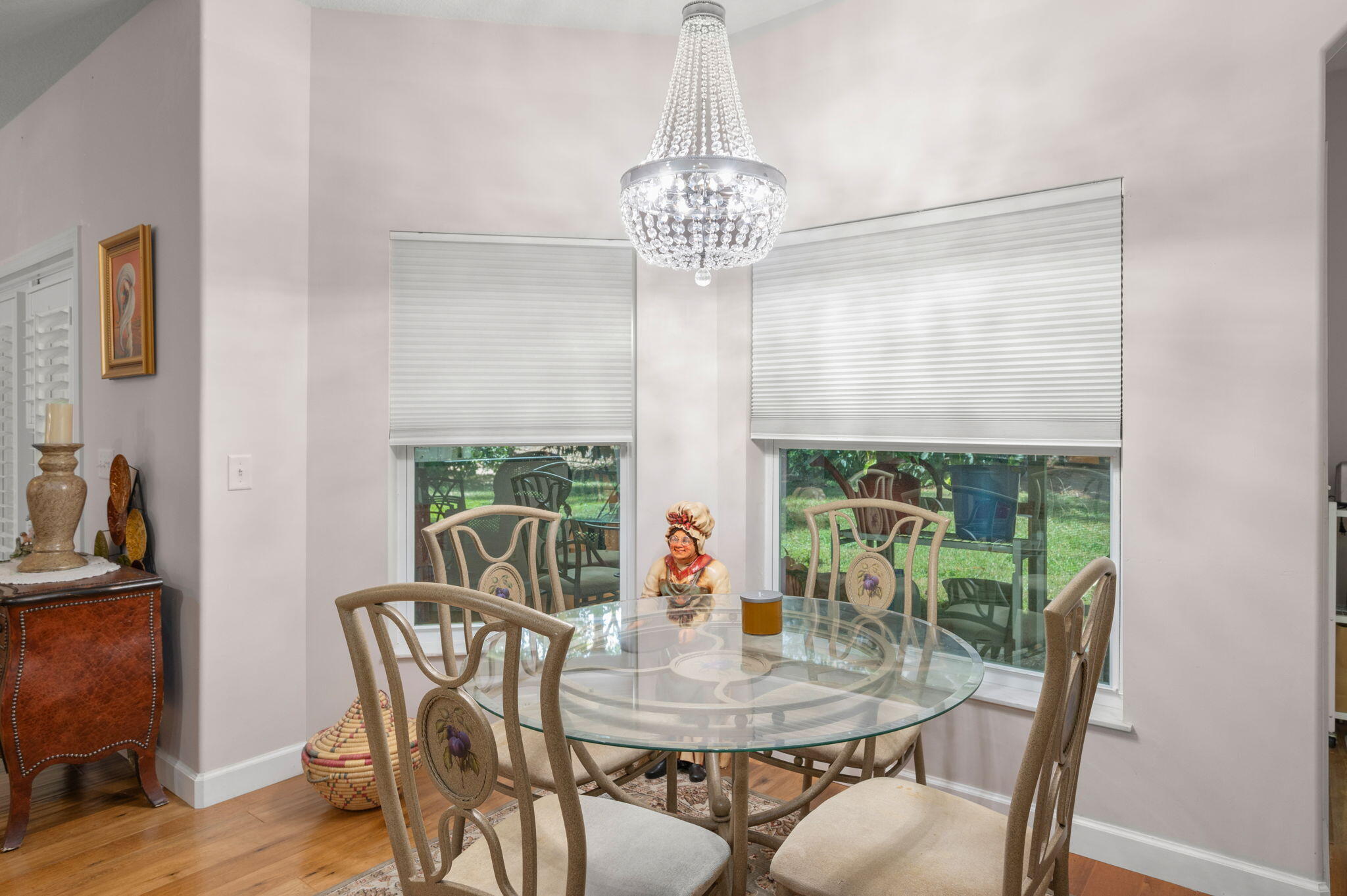 1545 Southwest Mockingbird Circle Port St. Lucie, FL 34986 - Photo 13 of 24 a view of a dining room with furniture wooden floor and a chandelier