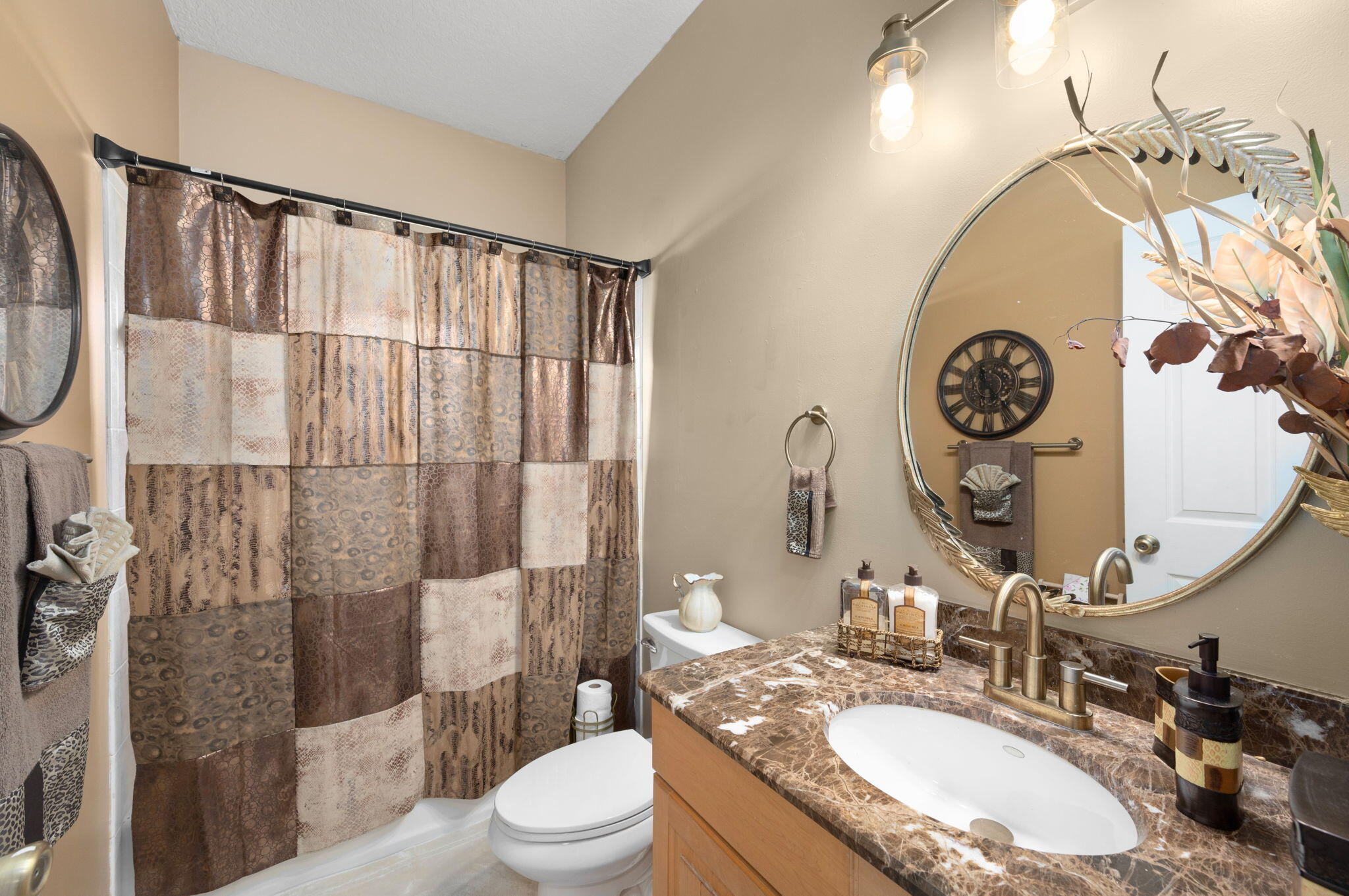 1545 Southwest Mockingbird Circle Port St. Lucie, FL 34986 - Photo 14 of 24 a bathroom with a granite countertop sink mirror vanity and toilet