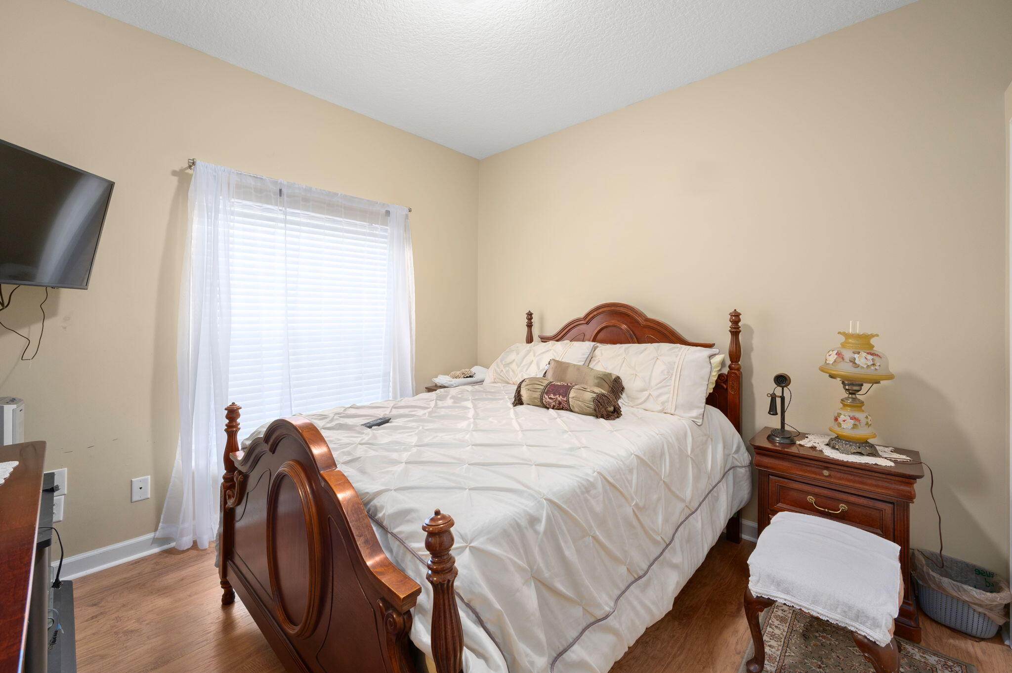 1545 Southwest Mockingbird Circle Port St. Lucie, FL 34986 - Photo 15 of 24 a bedroom with a bed and a chair