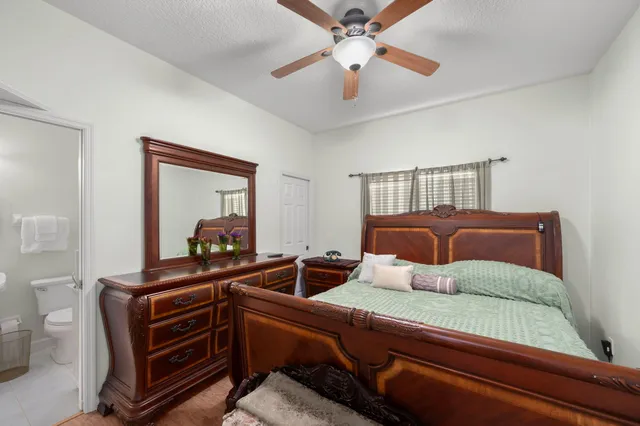 a bedroom with furniture and a mirror