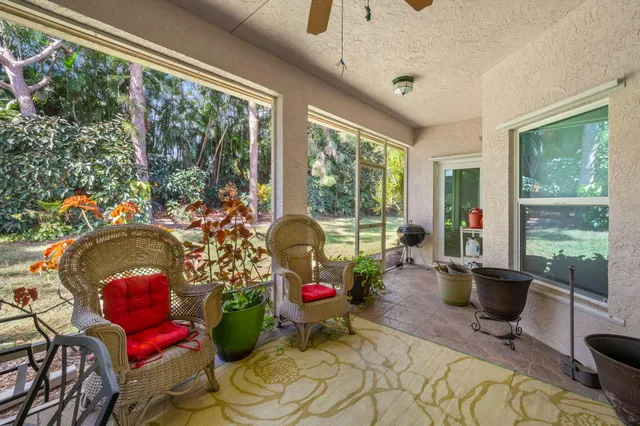 a living room with furniture and floor to ceiling windows