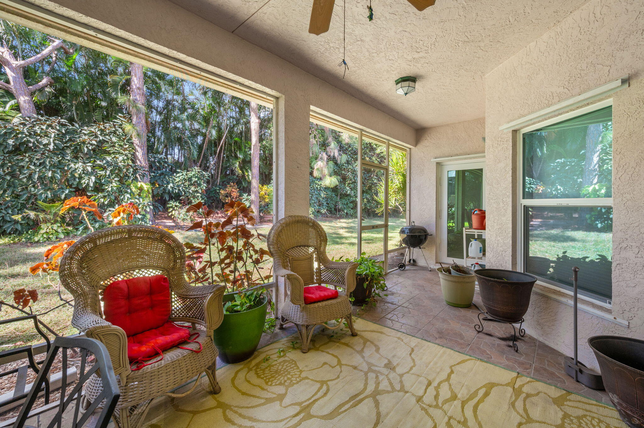 1545 Southwest Mockingbird Circle Port St. Lucie, FL 34986 - Photo 21 of 24 a living room with furniture and floor to ceiling windows
