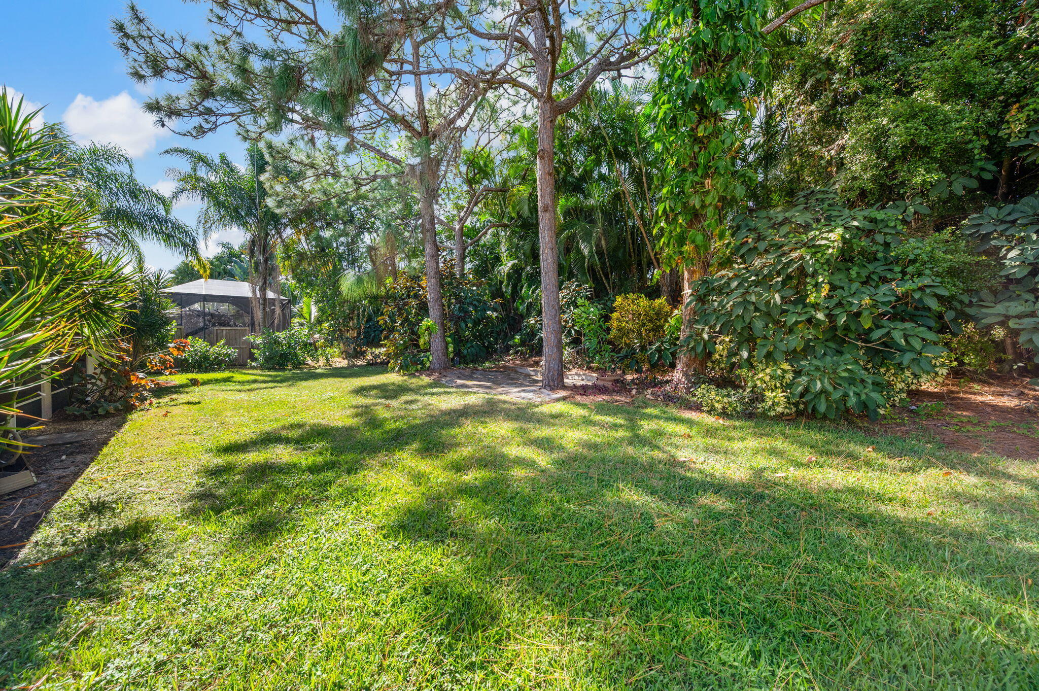 1545 Southwest Mockingbird Circle Port St. Lucie, FL 34986 - Photo 23 of 24 a view of yard with swimming pool and green space