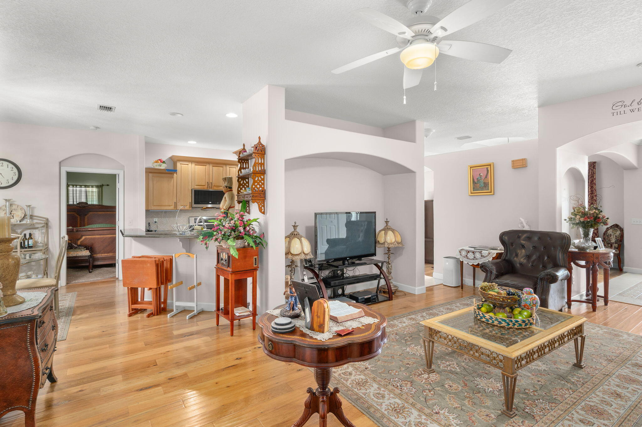 1545 Southwest Mockingbird Circle Port St. Lucie, FL 34986 - Photo 7 of 24 a living room with furniture a fireplace and a flat screen tv